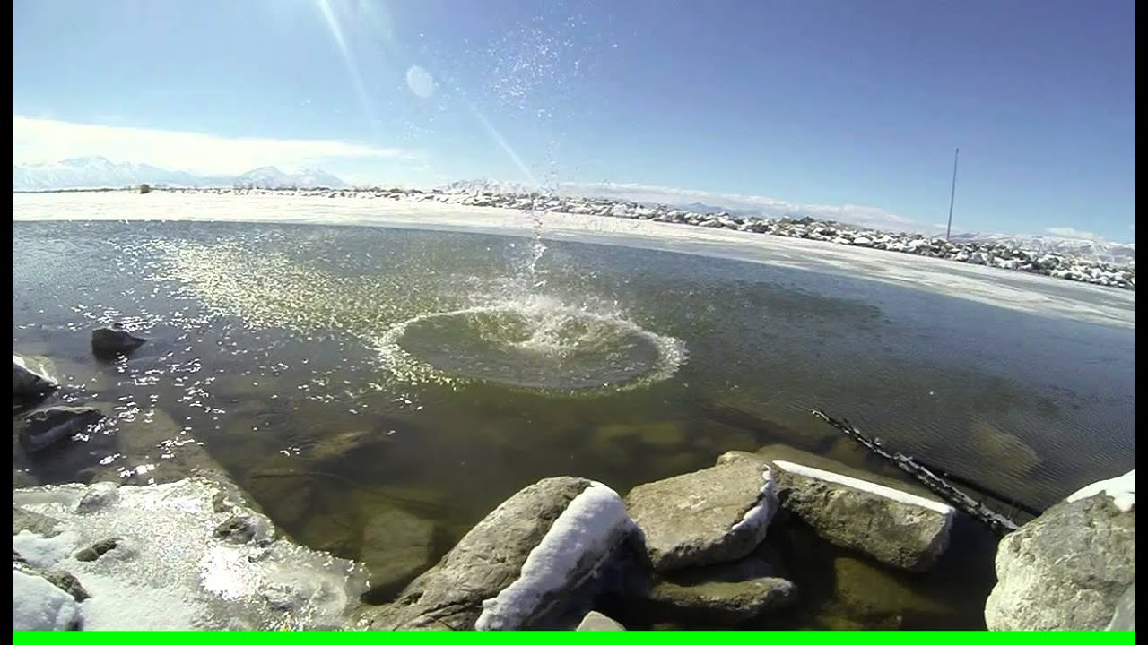Slow motion throwing rock into water