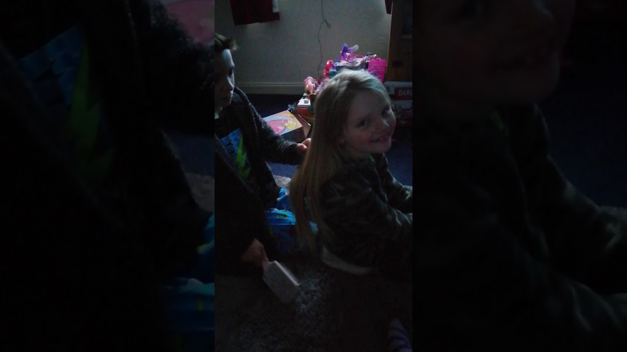 Big brother brushes little sister's hair