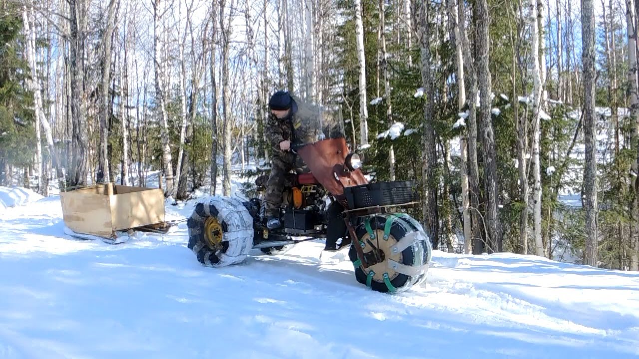 На самодельном трёхколёсном снегоходе за водой.