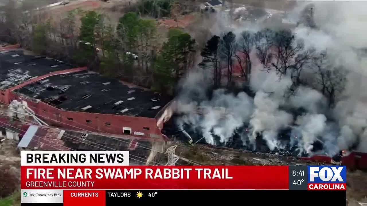 Crews battle fire that started in vacant building near Swamp Rabbit Trail