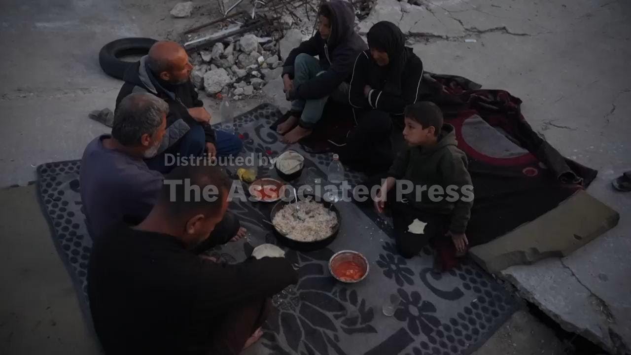 Displaced Palestinian family prepare their meagre iftar meal beside the ruins of a mosque
