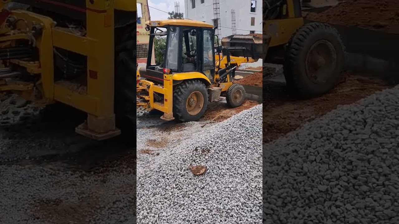 JCB 2DX filling mud in the columns of the building.
