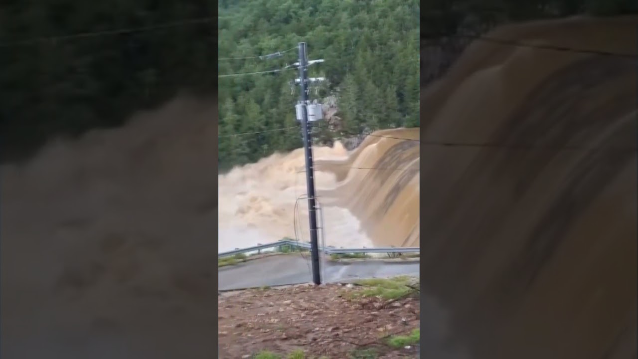 Roads wash out and a family is trapped in their truck as floods hit