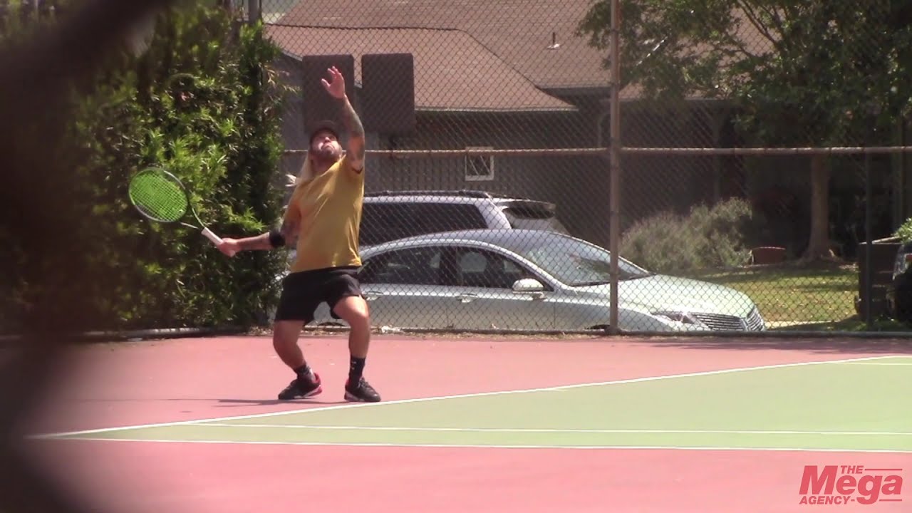 Fall Out Boy bassist Pete Wentz sports long blonde hair while playing tennis