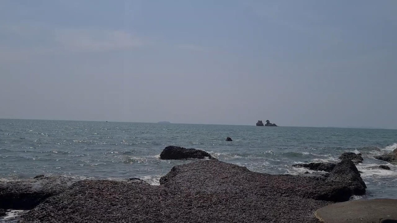 Relax with views of waves crashing against rocks and small islands in the sea.