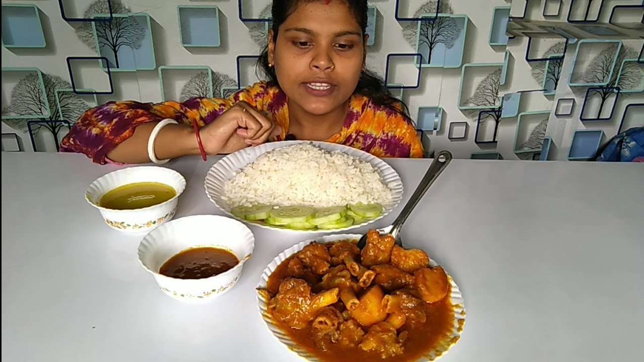 Eating spicy mutton Paya curry and rice,