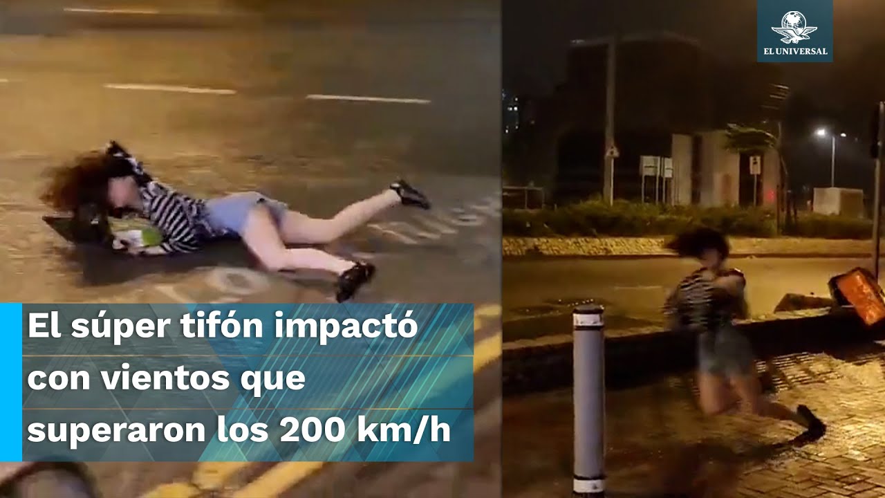 Mujer es arrastrada por fuertes vientos del tifón Saola en Hong Kong
