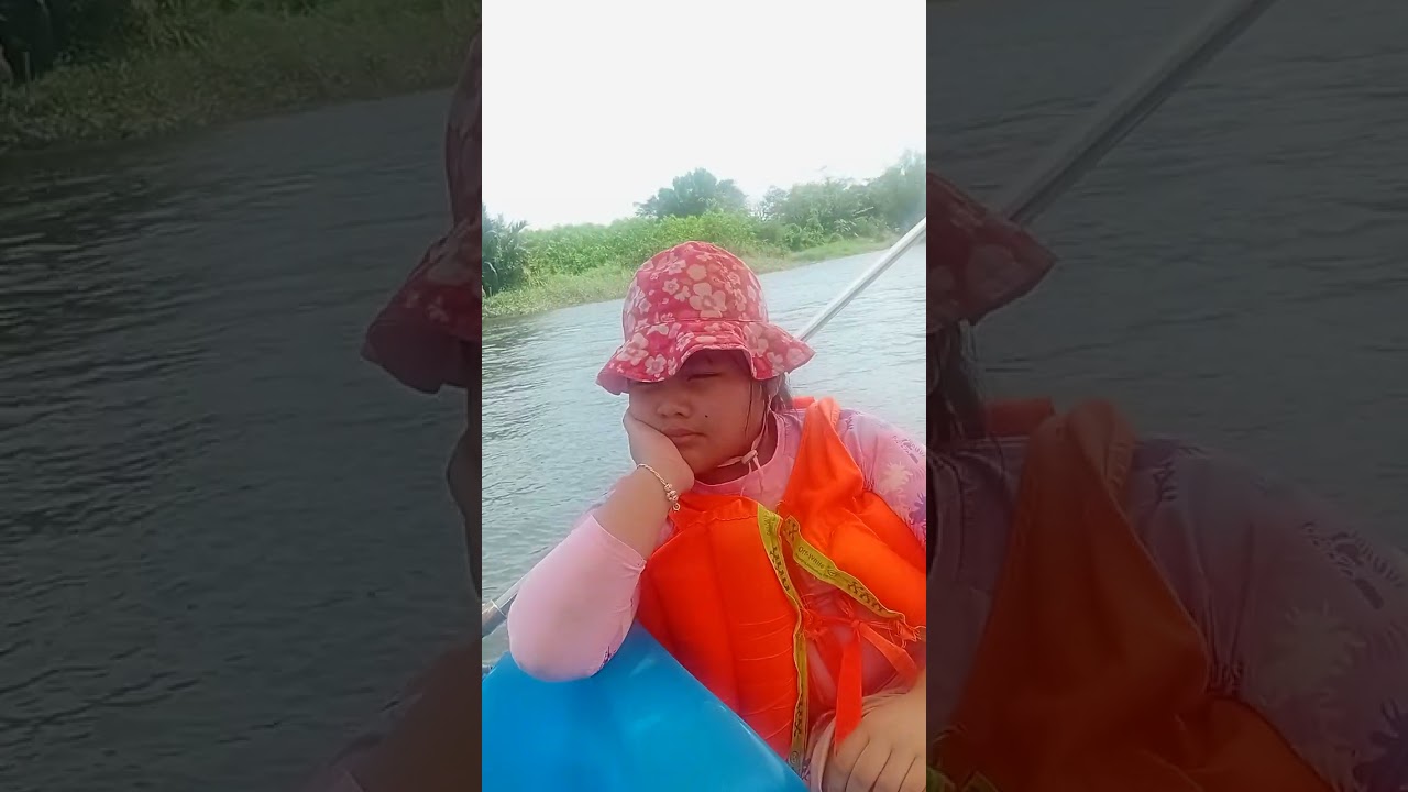The child is traveling by boat on the river. 