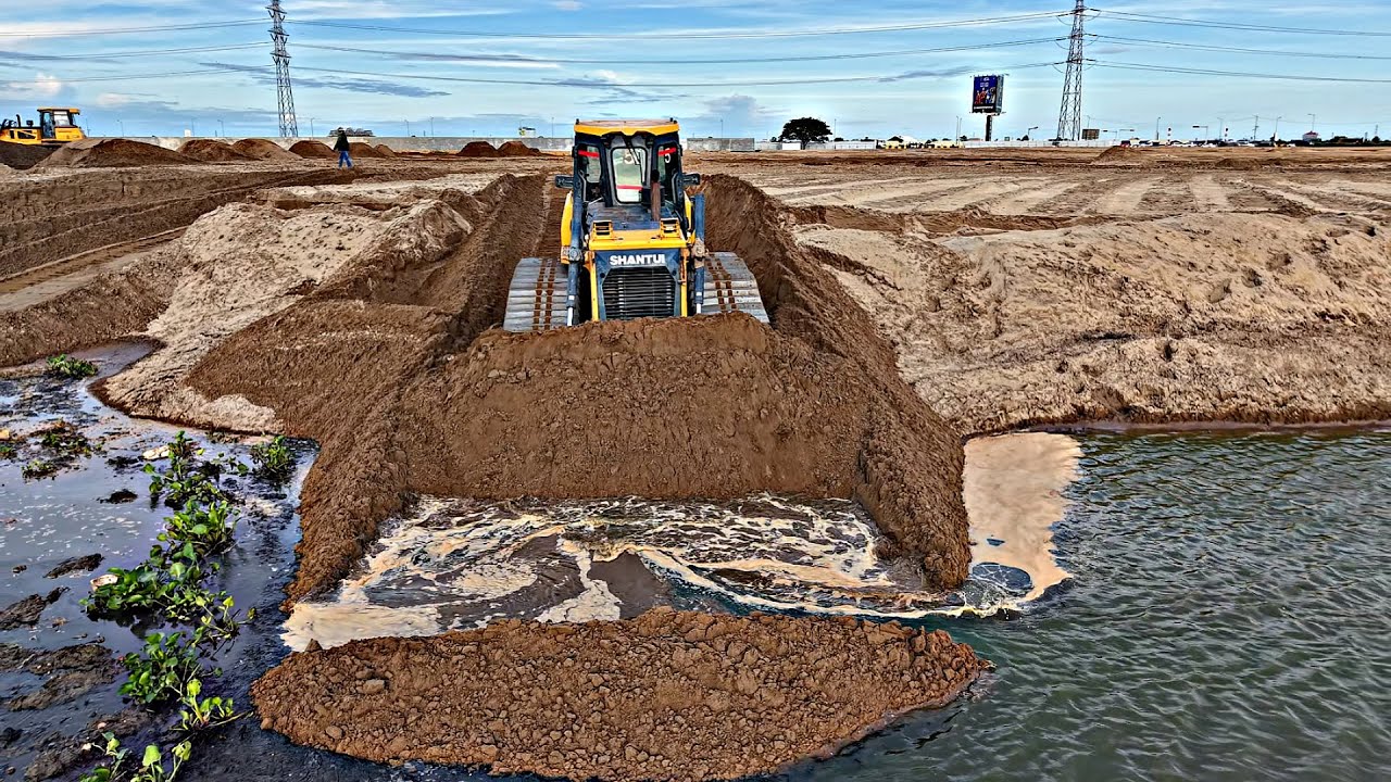 Incredible Activity Bulldozer SHANTUI pushing sand into the water &25.5ton dump trucks unloading.