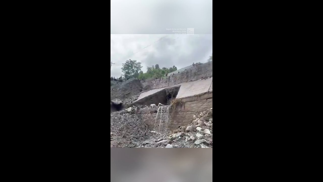 Landslide Sweeps Two Buses Into River