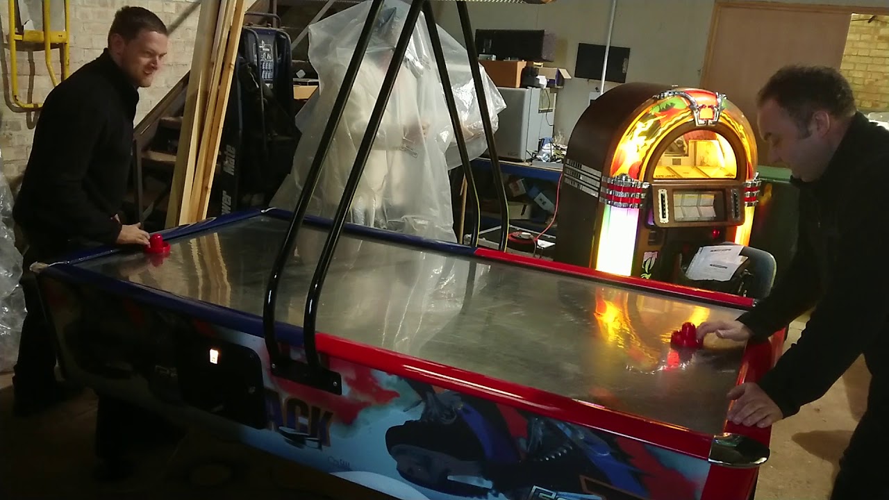 Two Scruffy Blokes Playing Air Hockey