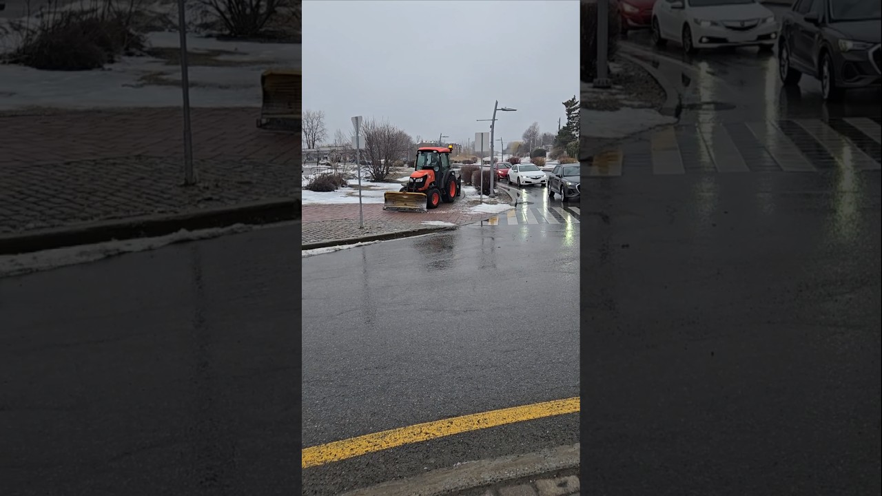 Sidewalk Plow Spreading Salt On Walkway
