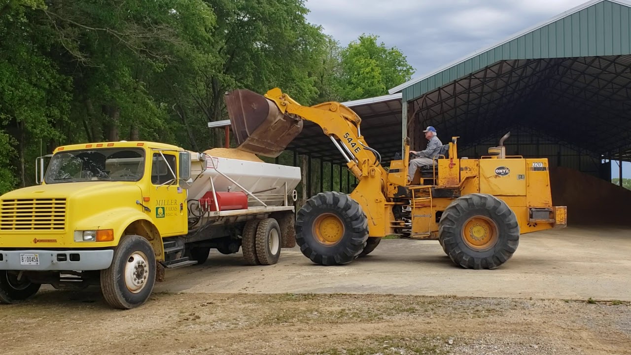 Spreading sawdust in our chicken houses after cleanout