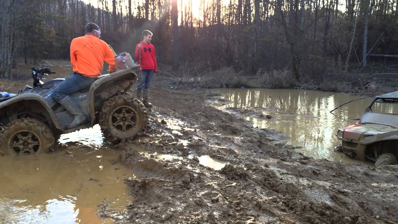 Crazy driver in stock polaris 570 rzr skimming across a mud hole.