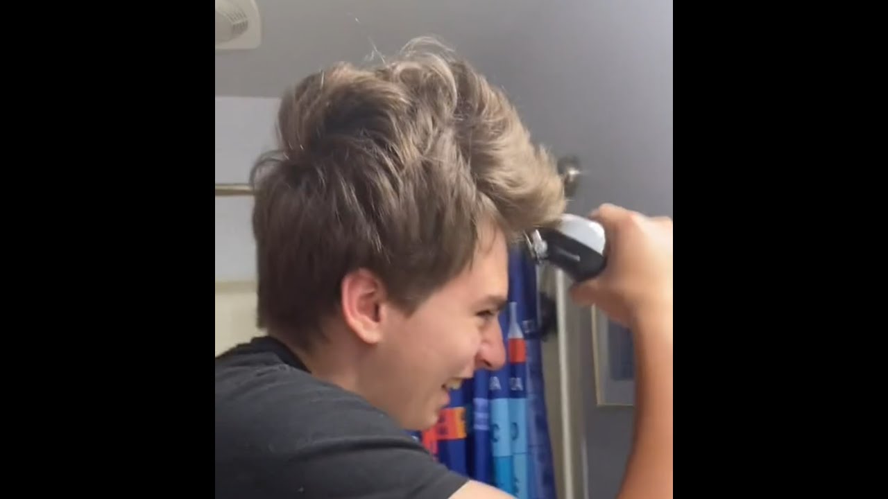 Boy getting his head shaved in the bathroom [22L26D]