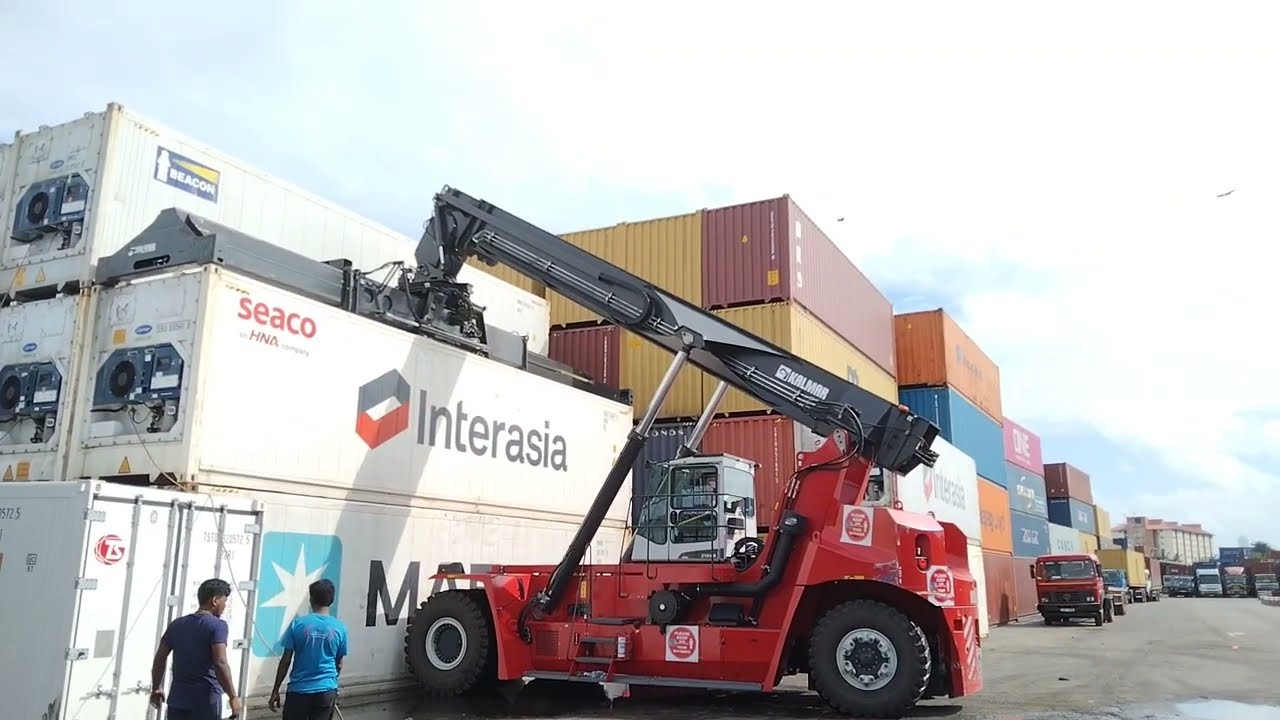 Kalmar Reach stacker with a tilting spreader for container handling.