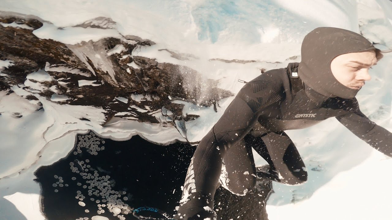 Ice cold cliff diving and snowmobiles