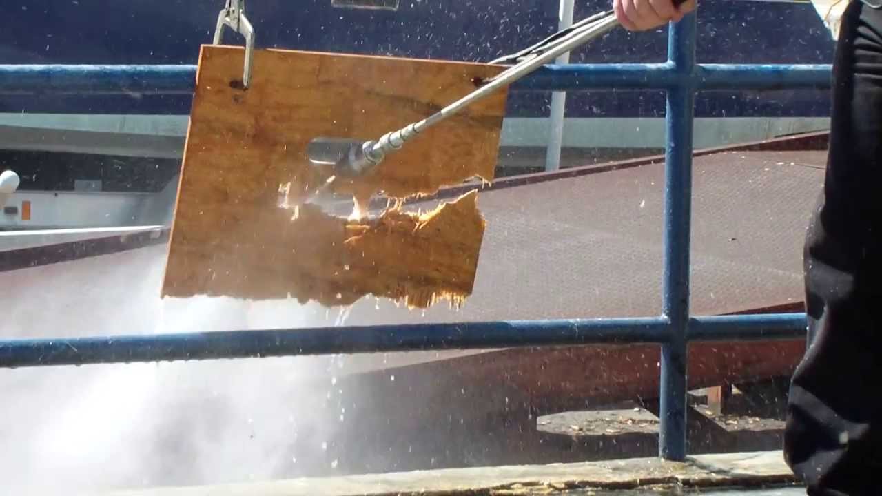 Diesel powered 7000 PSI pressure washer cutting a sheet of plywood in half. Insane power!