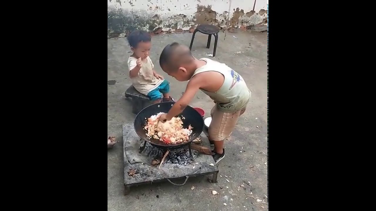Little boy cook the fried Rice