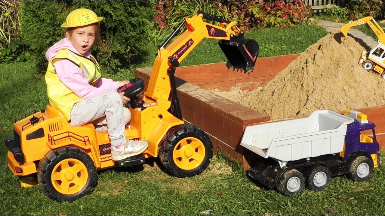 Sofia on a Toy Excavator makes a Children's sandbox