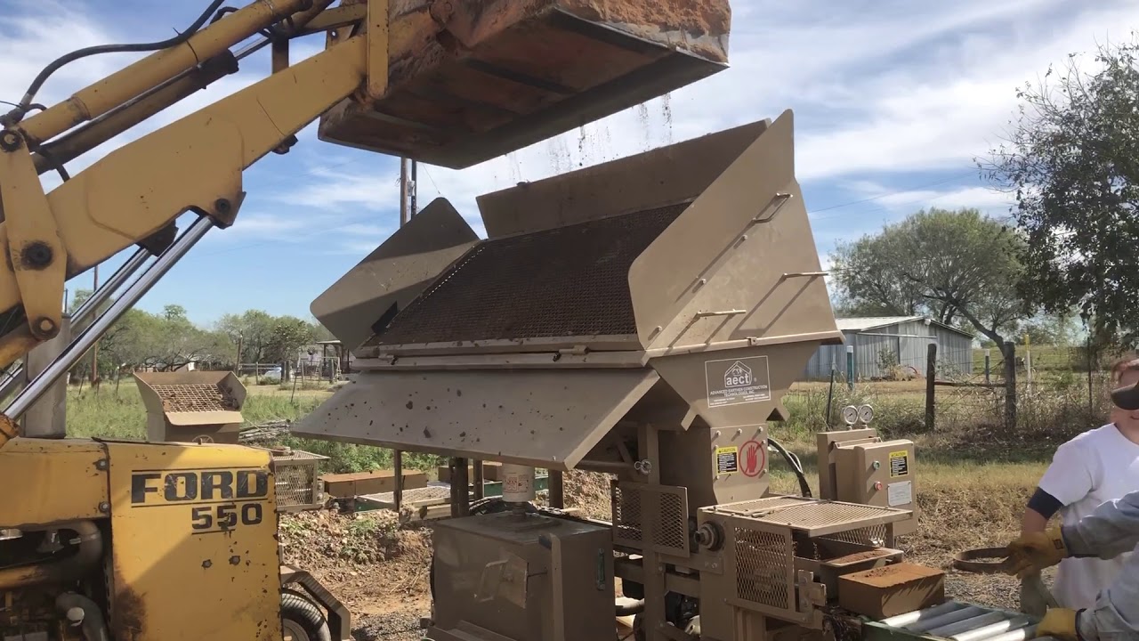 AECT 2500 compressed earth block machine at work