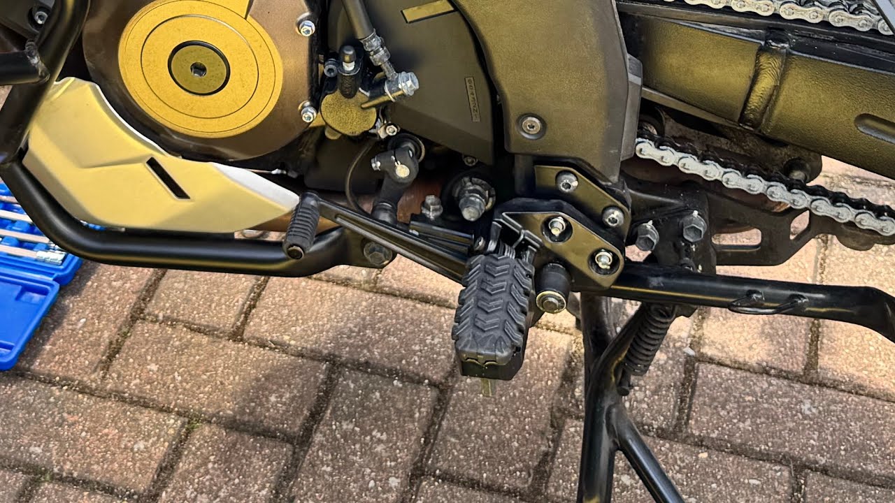 Fitting the foot peg lowering kit onto a ￼Suzuki V Strom 1050XT. ￼