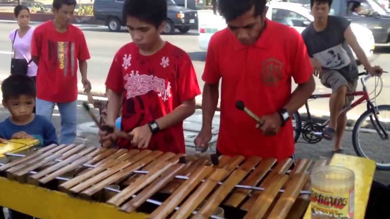 Amazing Filipino music using a self-made bamboo instrument by a father and son along Manila bay walk