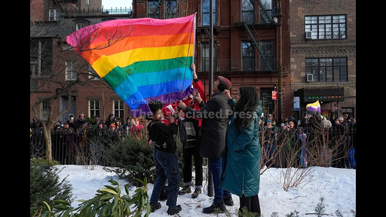NY officials raise a rainbow flag at Stonewall before a boisterous crowd after Trump-era removal