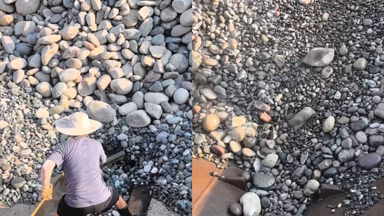 Unloading pebbles is so relaxing for cargo ship workers!