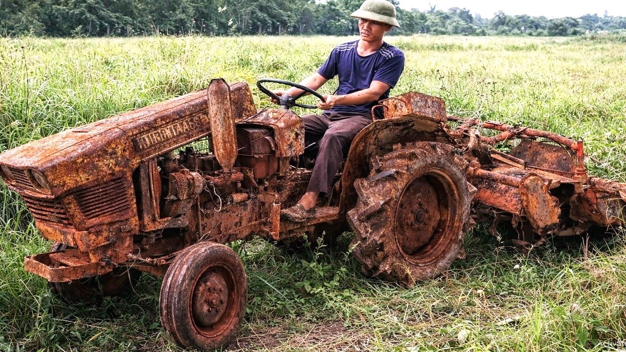 Restoring a dilapidated old tractor abandoned for years in a deserted field.