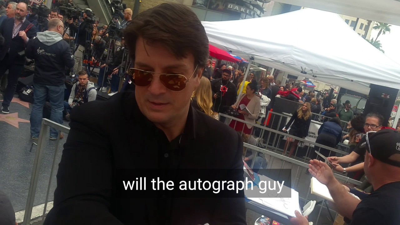 nathan fillion signing autographs at the ryan reynolds star ceremony