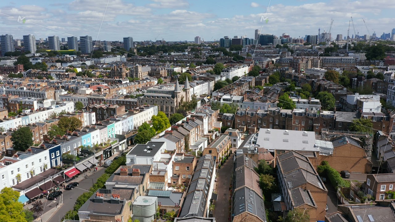 Panorama curve footage of urban neighbourhood. Rows of family houses along streets. Downtown