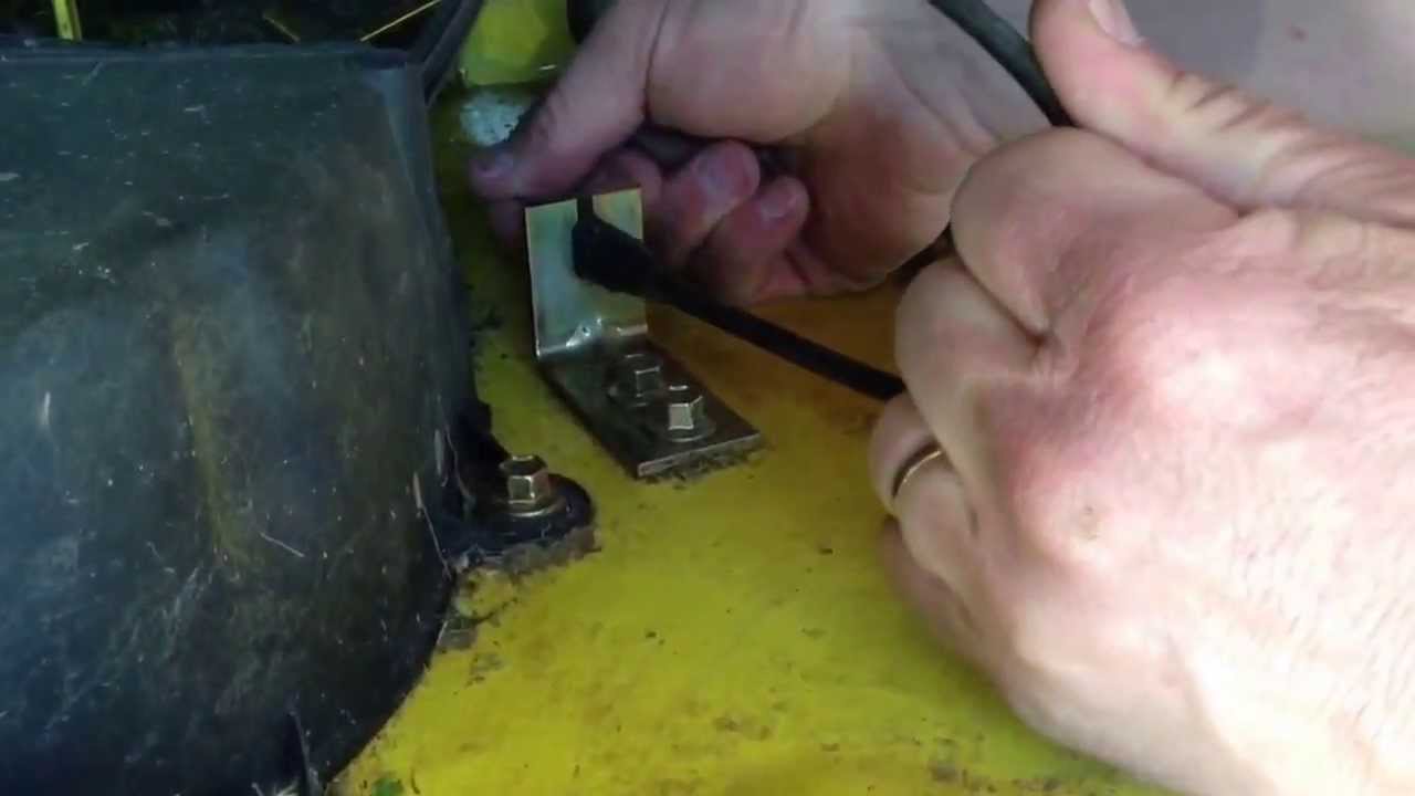 Tightening the belt on a John Deere L110 Tractor