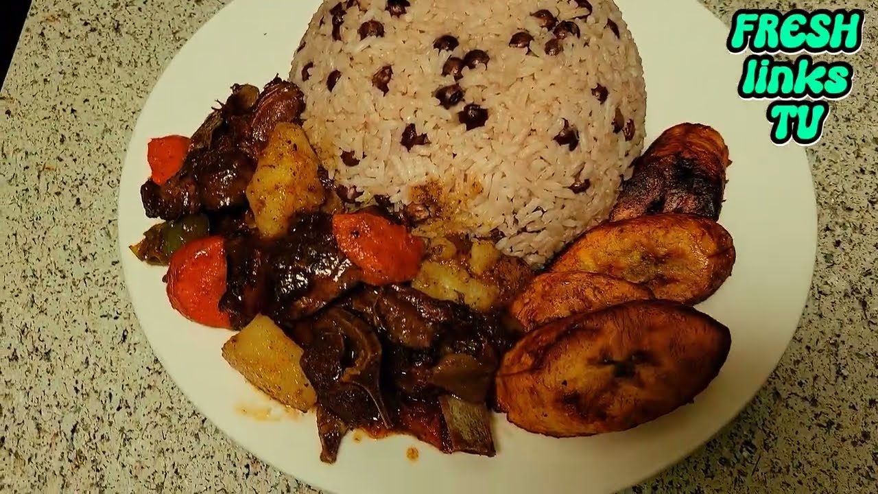 BROWN STEW GOAT WITH GUNGO RICE JAMAICA STYLE. 