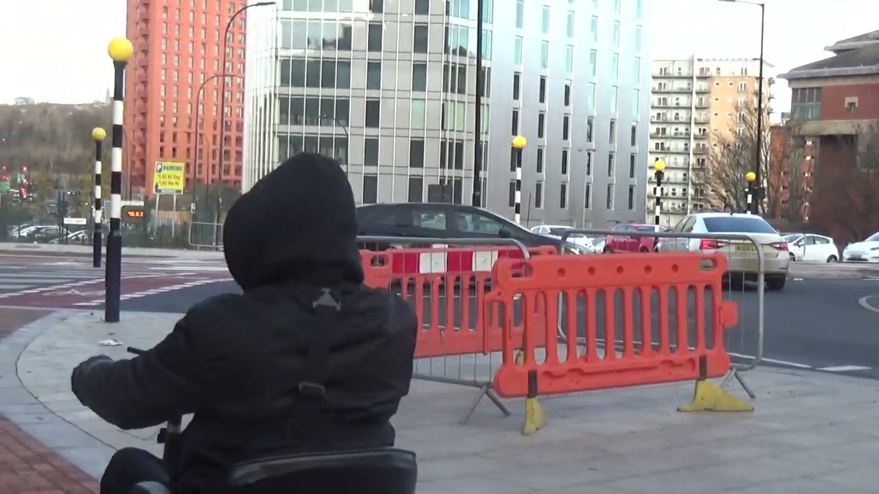 Sheffield city centre West Bar clown Dutch roundabout madness@BANAMAN on his mobility scooter
