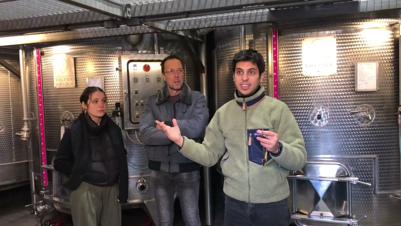 Francesco leads a tour of Castello di Volpaia winery showing the underground cellars and oak barrels