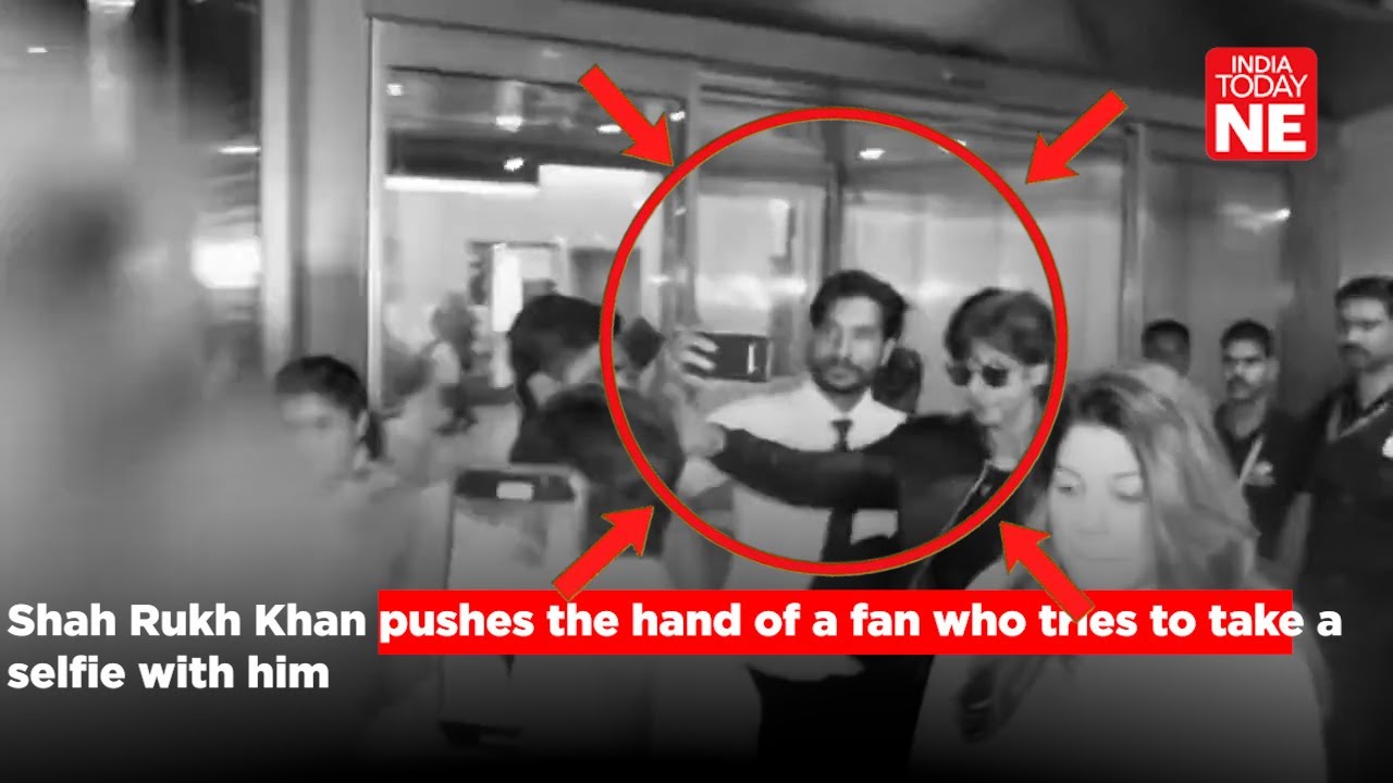 #WATCH:Shah Rukh Khan faces backlash after he pushes away the hand of one of his fans.