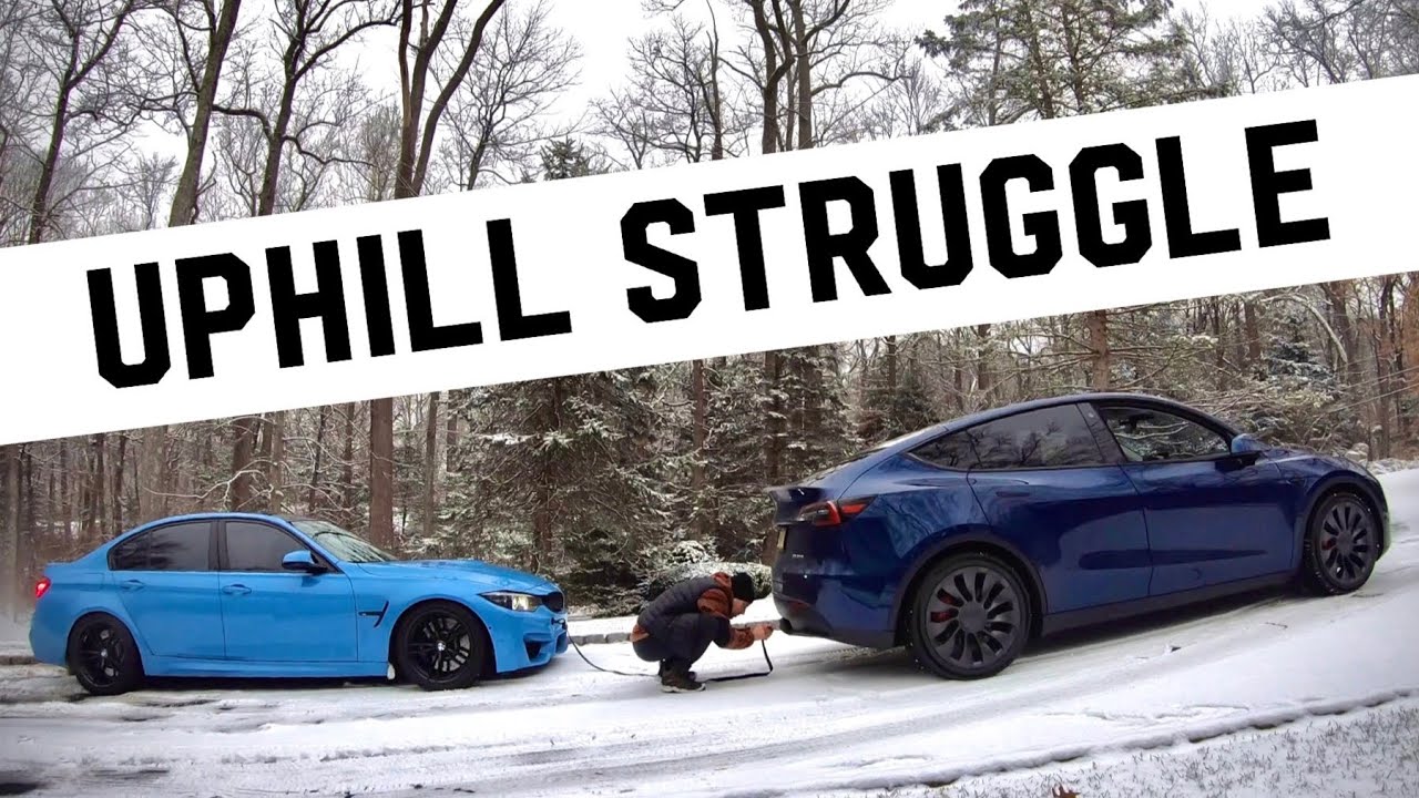TESLA pulls out a BMW M3 stuck in the snow.