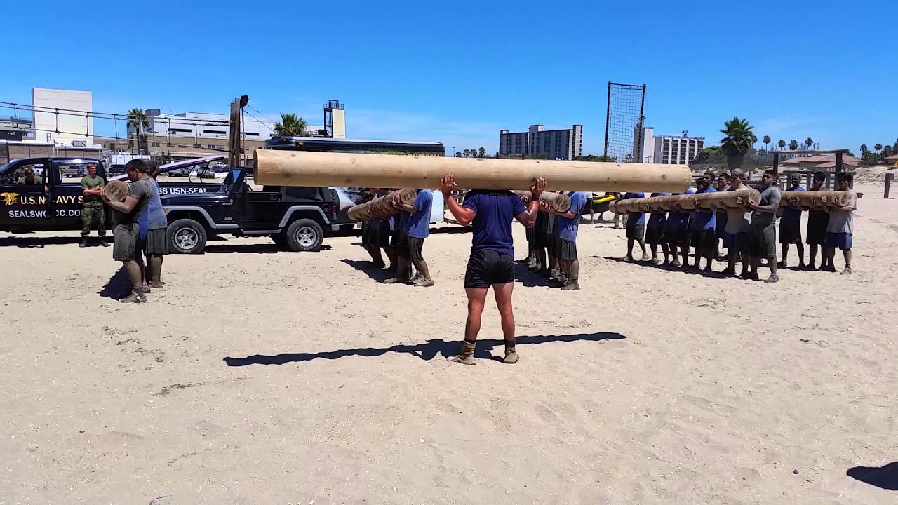 Navy SEAL showing RB Football how to lift a log