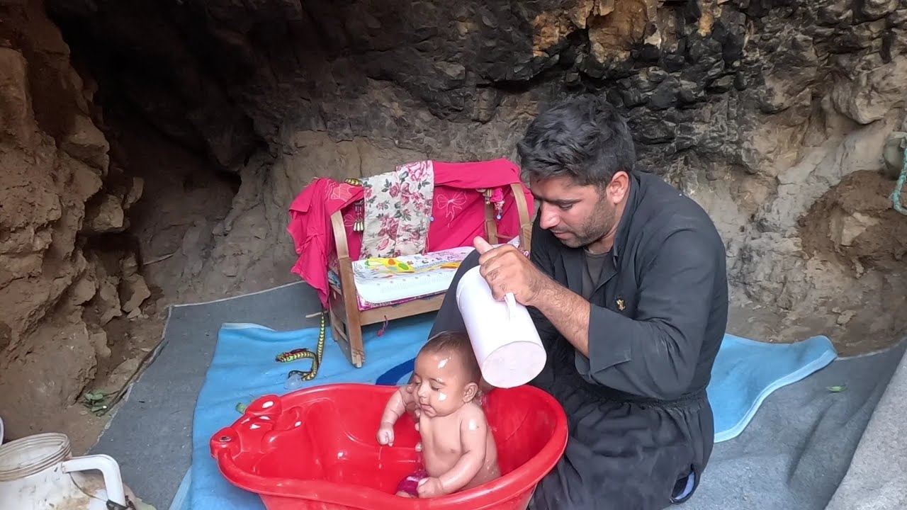 Washing the baby and feeding him dry milk by his father