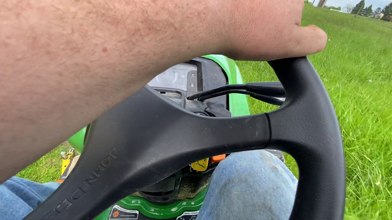 John Deere x758 in tall grass mowing
