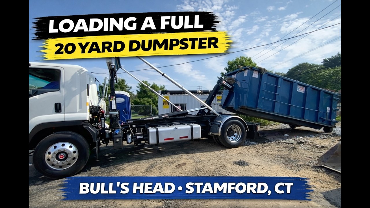Isuzu FVR 33,000 GVWR 12-ton Swaploader Hook Lift Truck Loading a Full 20 Yard Dumpster at Job Site