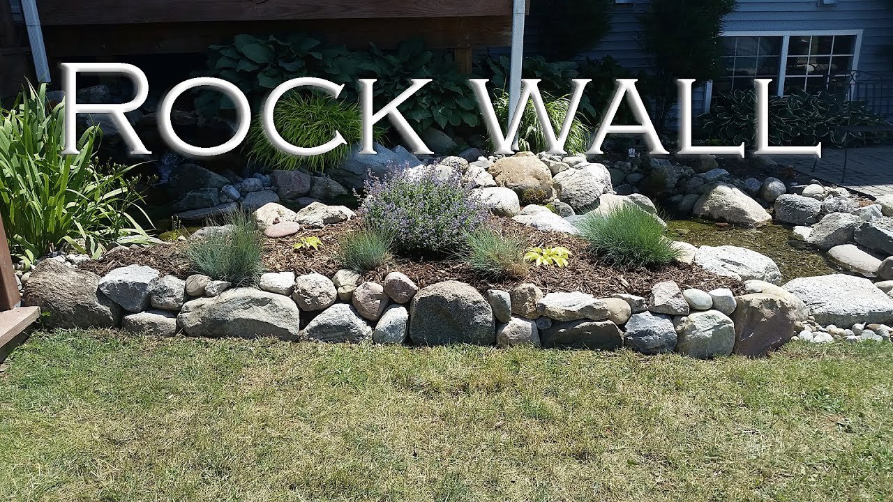 Setting up a rock wall to prevent erosion of soil