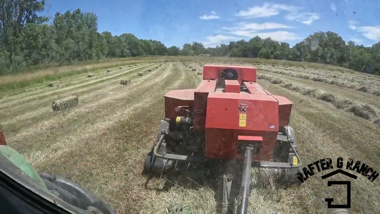 mowing, raking, baling, and accumulating the last field of 1st cut for 2022
