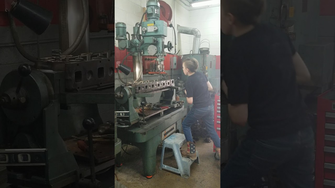 International 1466 tractor cylinder head.  Installing valves with a Winona PH6000.
