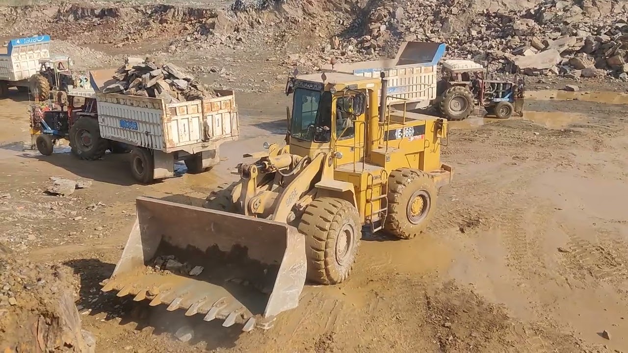 Powerful Caterpillar Loader Loading Giant Stones in Mountain Quarry
