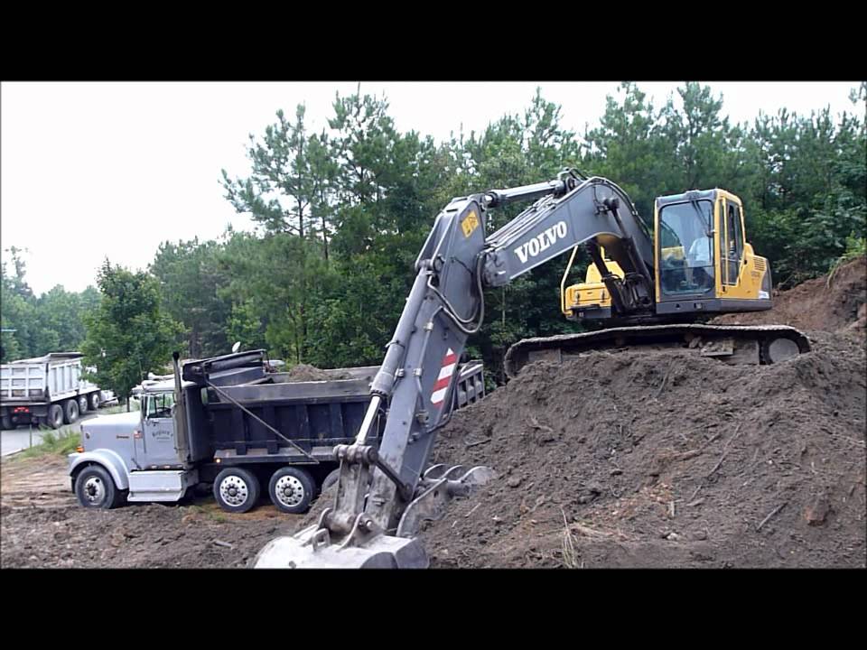 Volvo EC210 Excavator Rocking Out Trucks