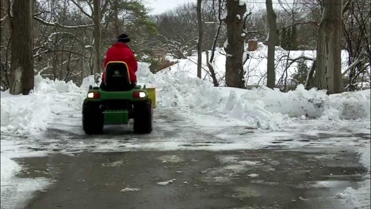 John Deere X485 plowing snow