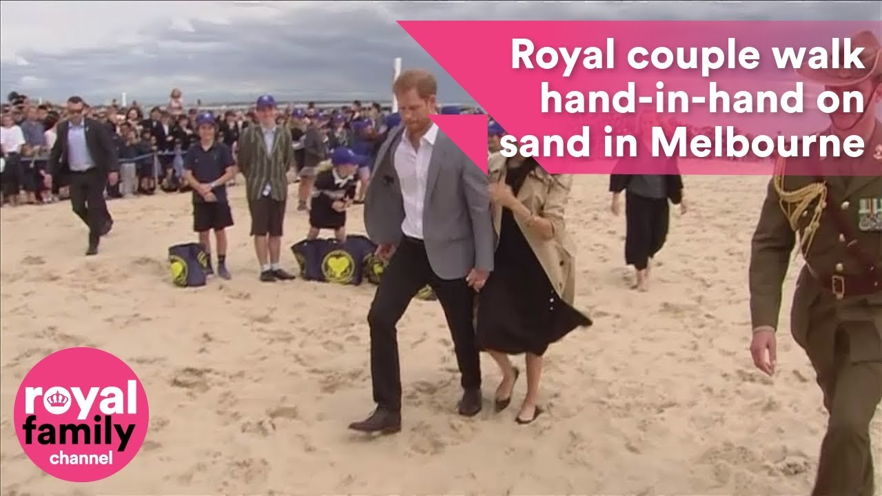 Prince Harry and Meghan walk hand in hand on Melbourne beach