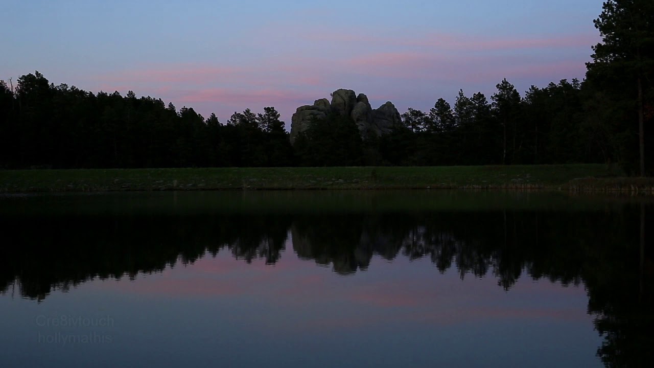 Tranquil lake with waterfall sound, frogs croaking and birds singing.
